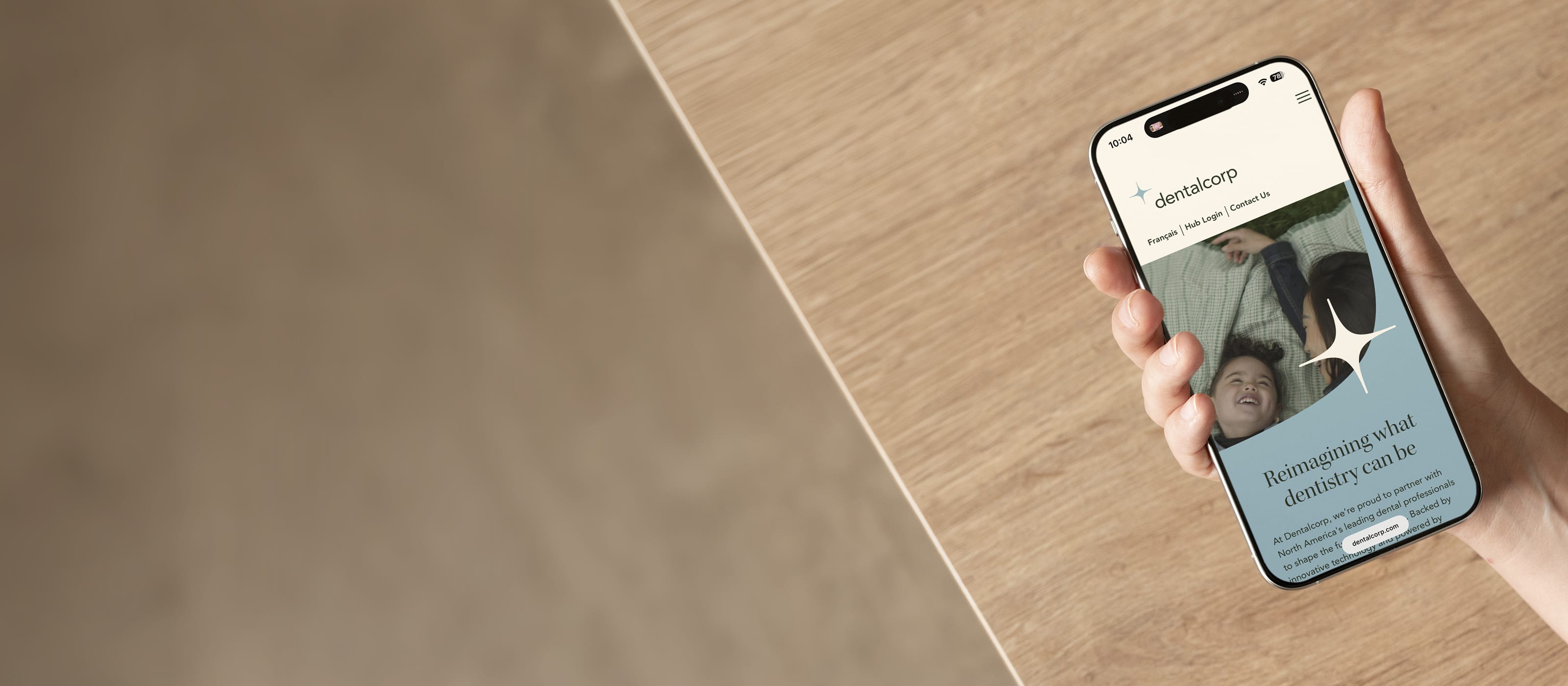 A phone shows the DentalCorp corporate website.