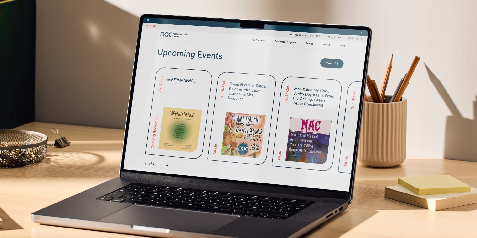 A laptop on a desk with the Niagara Artists Centre website displaying on it.