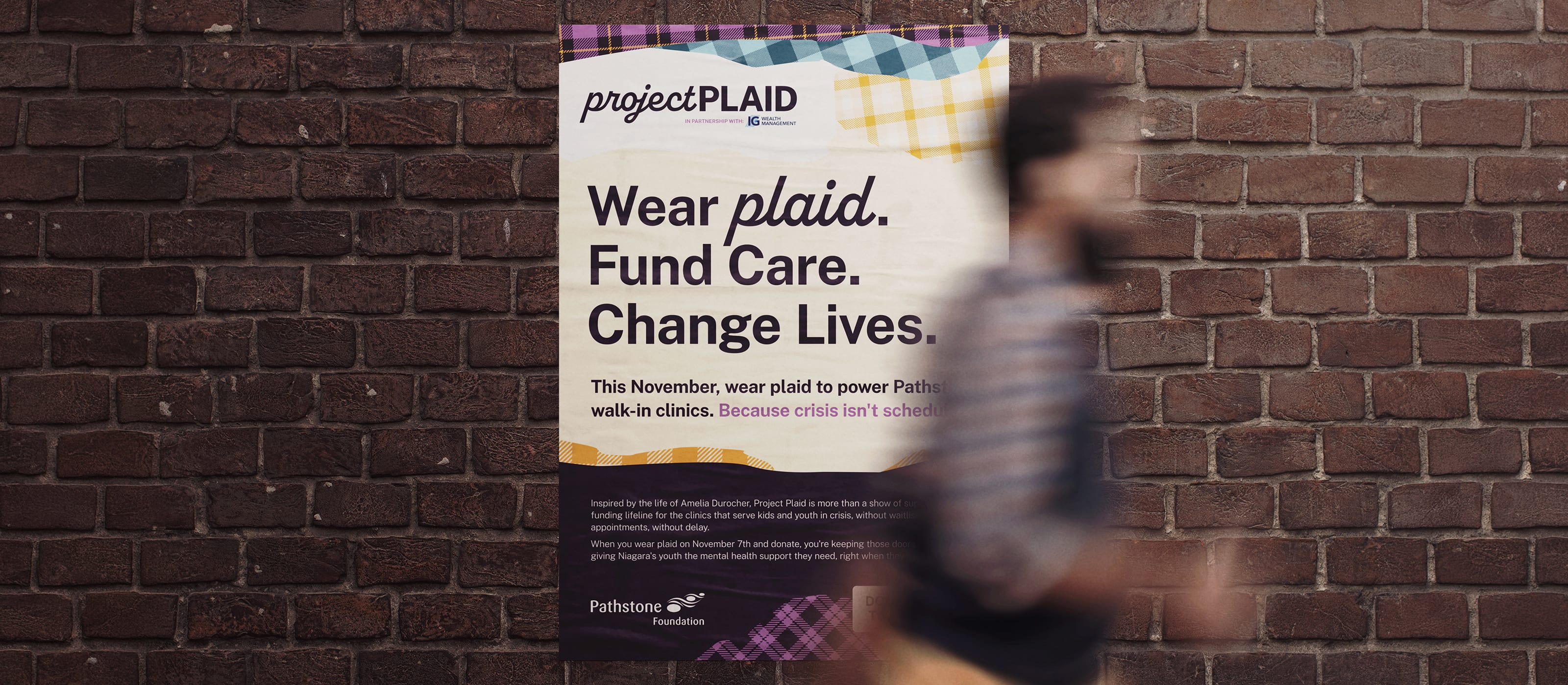 Brick wall with a poster for project plaid from the Pathstone Foundation. A blurry person is walking past it.